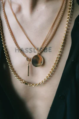 man-wearing-multiple-necklaces